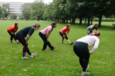 Fit Happy's Edinburgh boot camp for women. Ladies stretching in the Meadows.