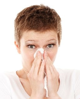 Lady sneezing with winter cold or virus