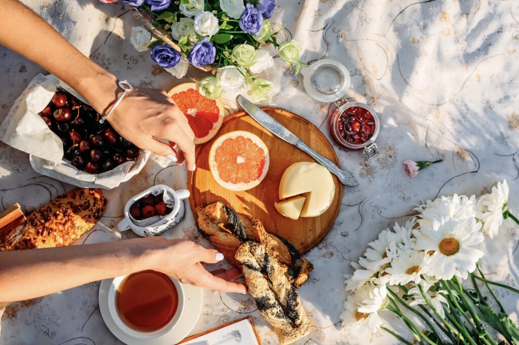 An aerial view of a table outside spread with a selection of food to enjoy