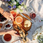 An aerial view of a table outside spread with a selection of food to enjoy